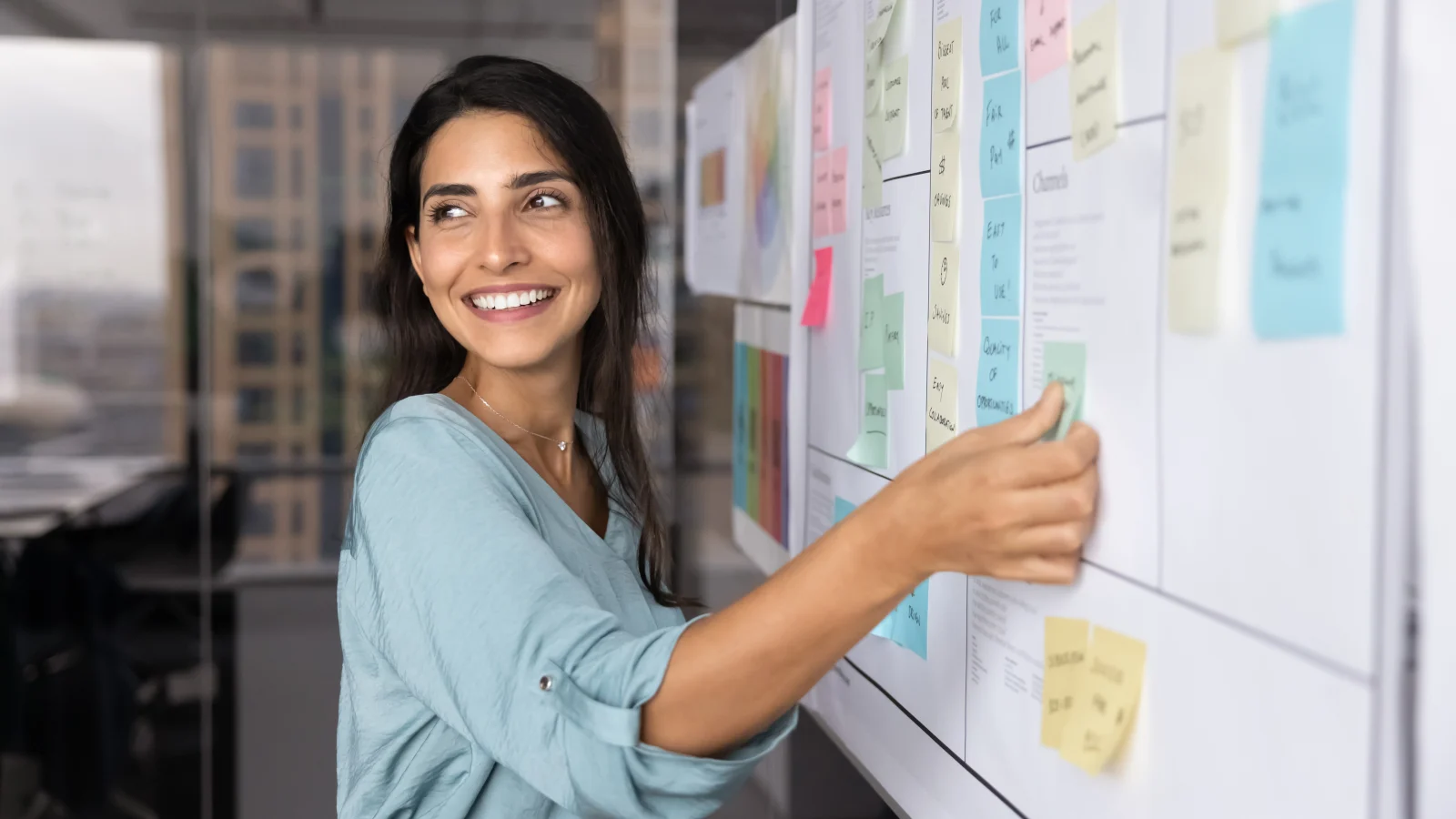 An engineer working through a planning wall of notes