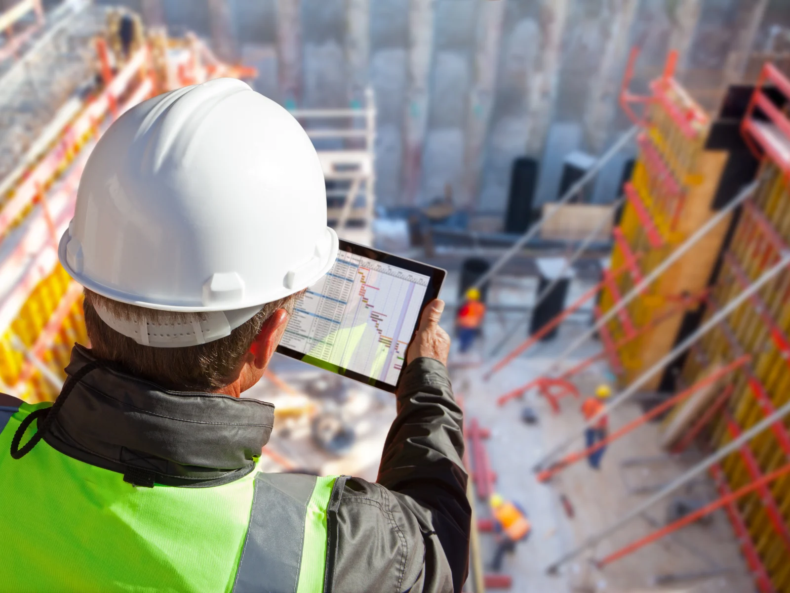 Construction professional reviewing a project schedule on site