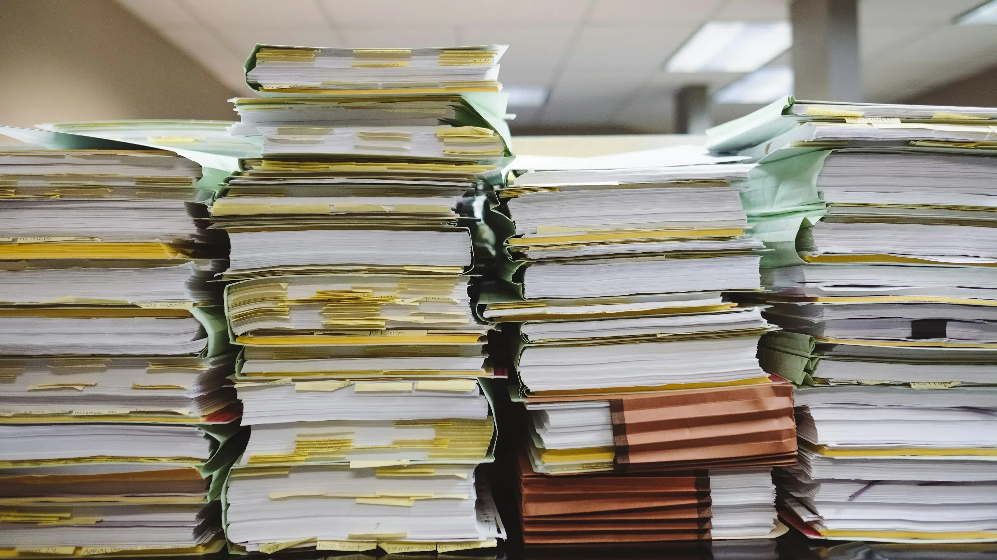Printed documents spread across a desk for comparison