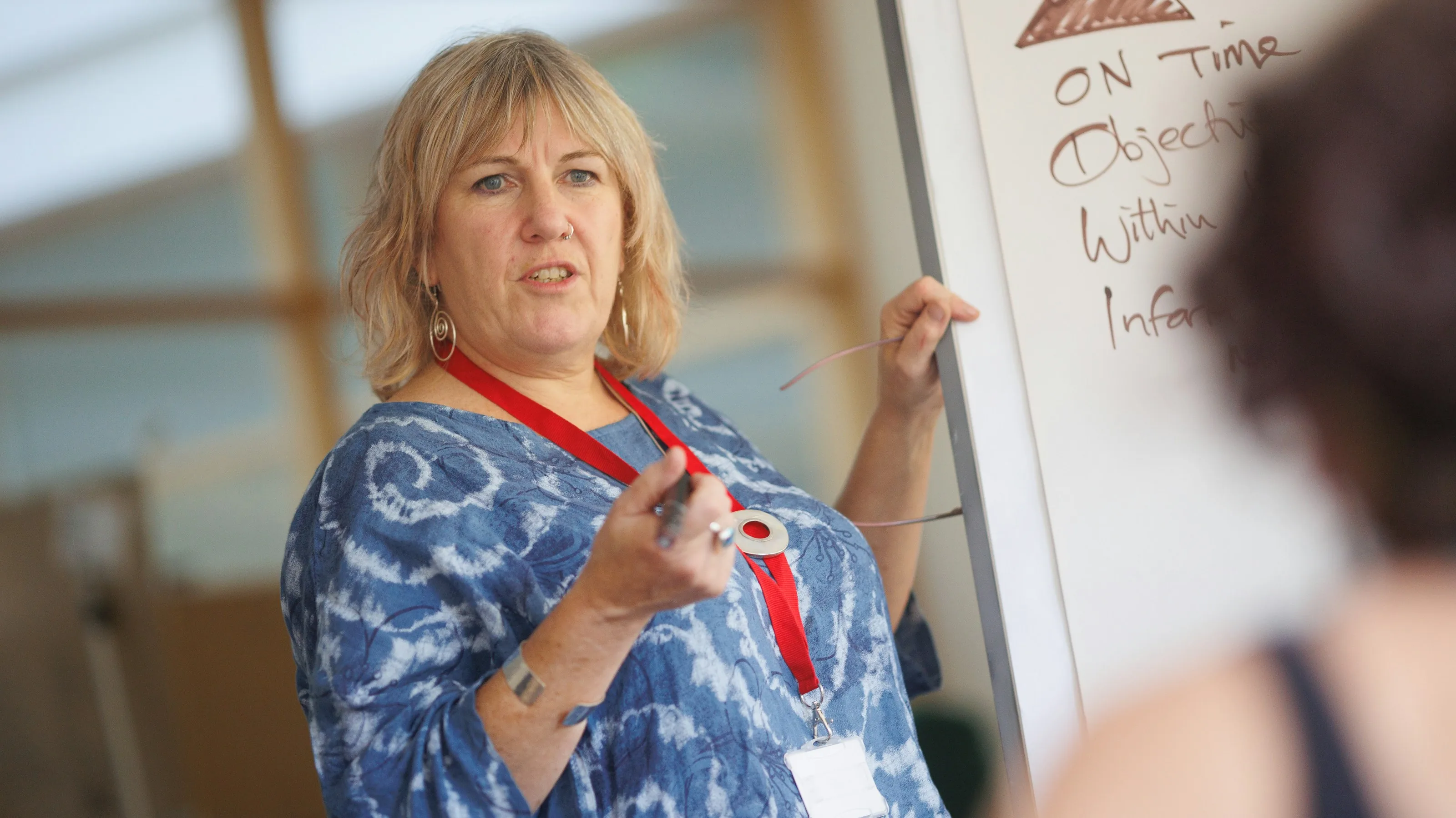 A trainer presenting to a small group in a meeting room
