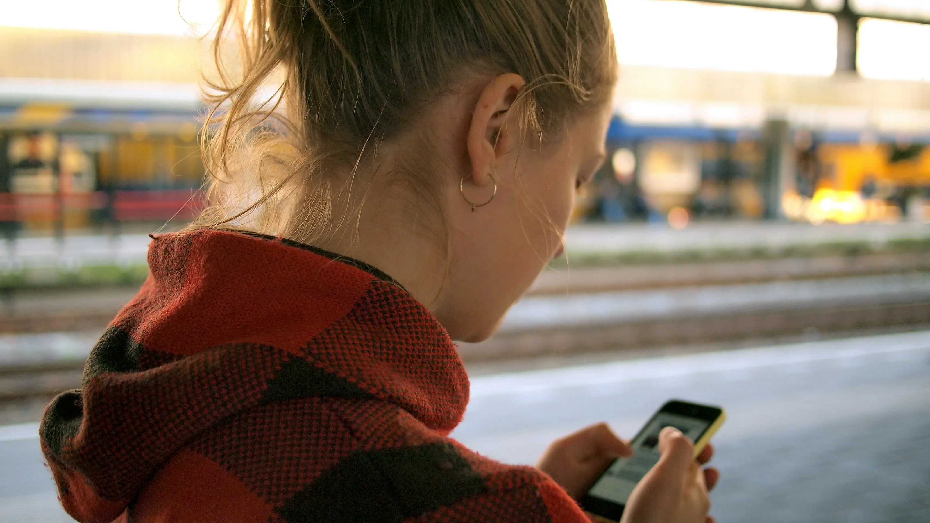 A person checking a smartphone while commuting