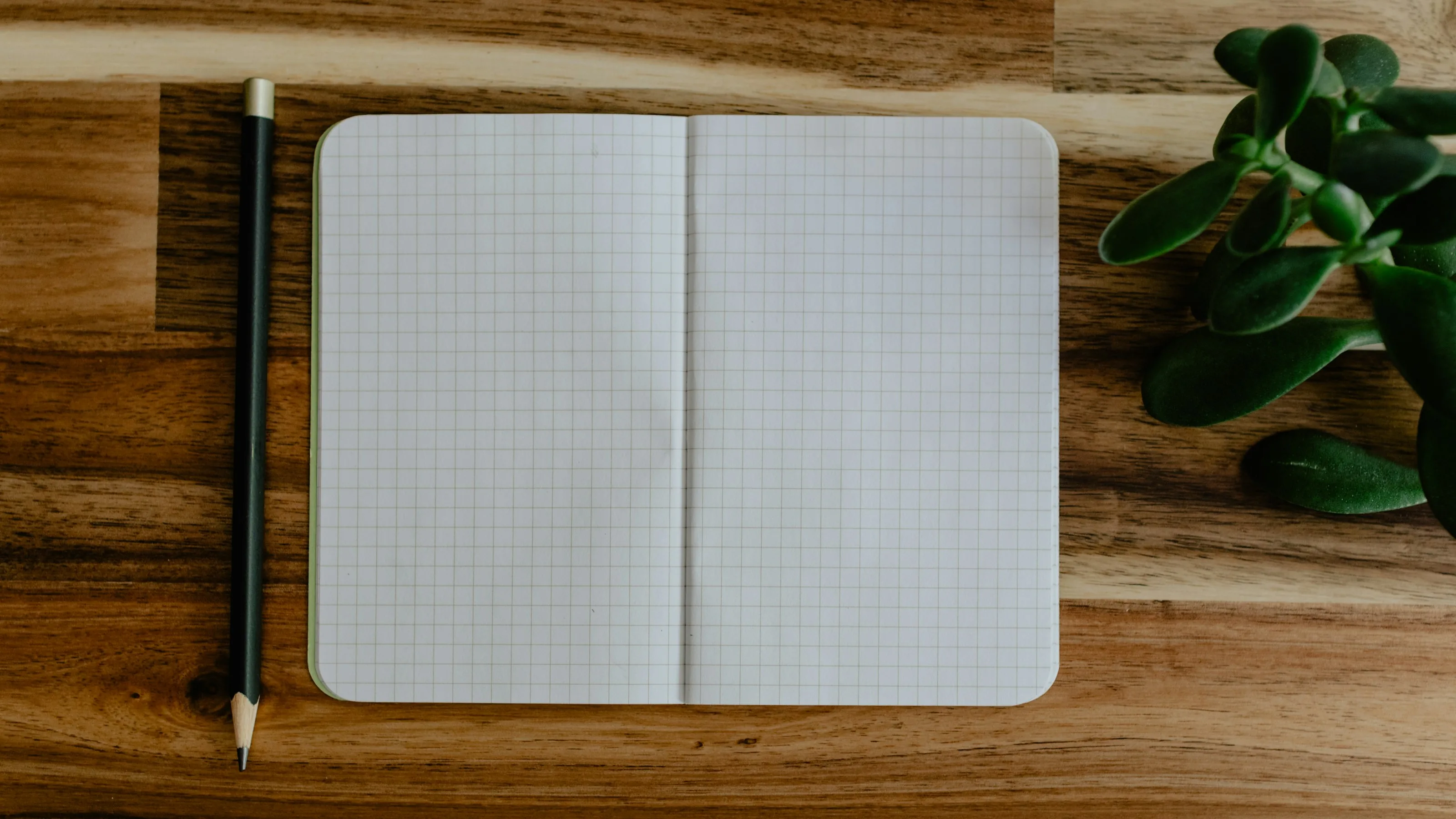 A notebook of handwritten questions on a meeting table
